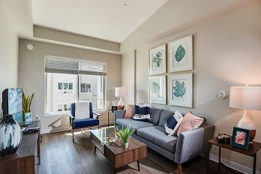 A modern living room with stylish decor and abundant natural light.