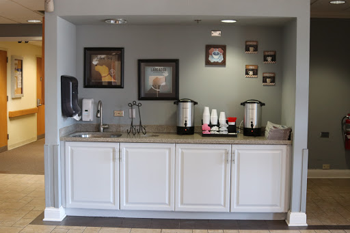 A cozy breakfast area featuring a coffee station and decorative wall art.