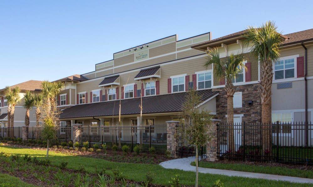 A modern residential building with a landscaped exterior and contemporary architectural design.