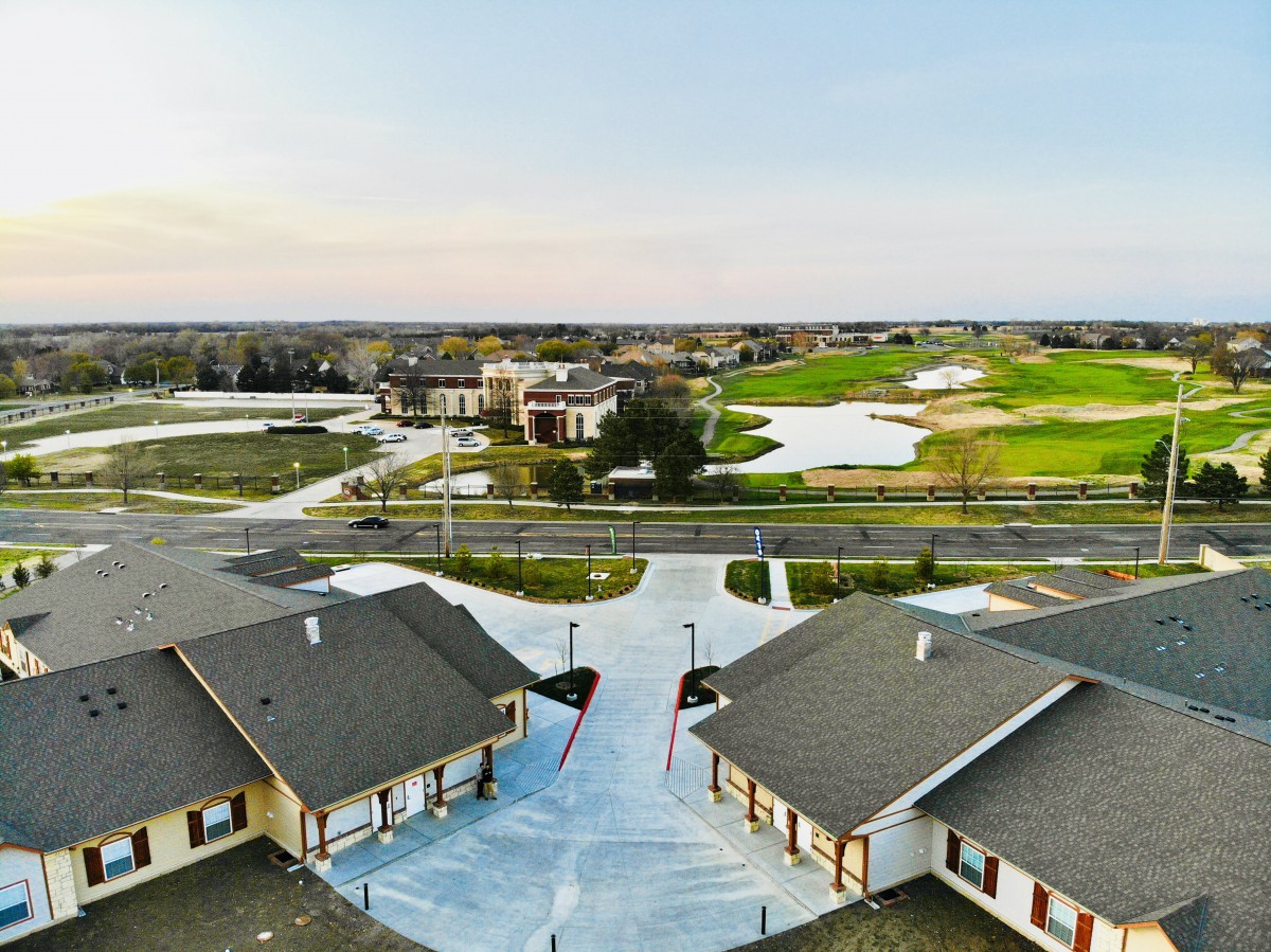 Aerial view of a suburban neighborhood with homes near a golf course.