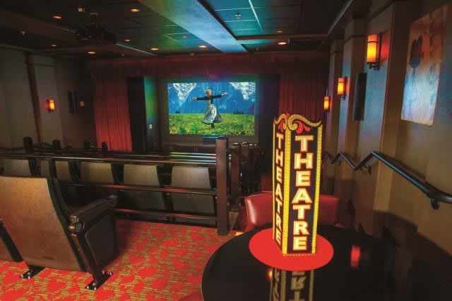 A cozy home theater setup with a large screen and comfortable seating.