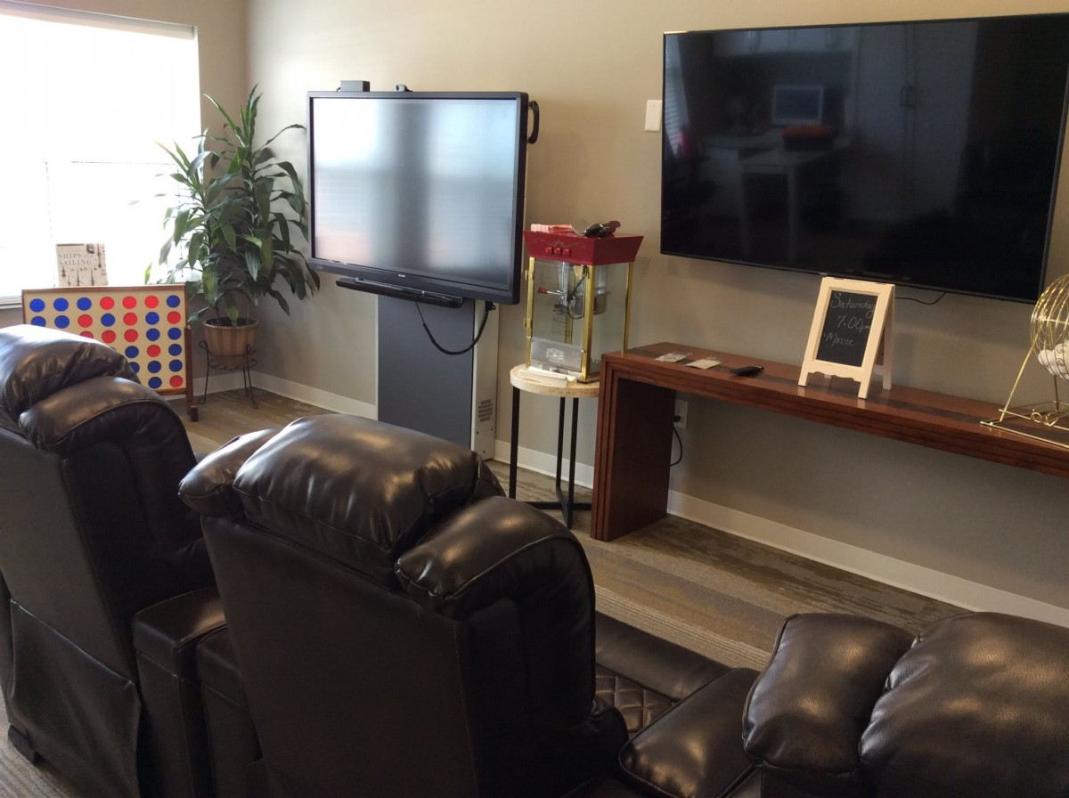 Cozy living room with comfortable recliners, a television, and entertainment amenities.