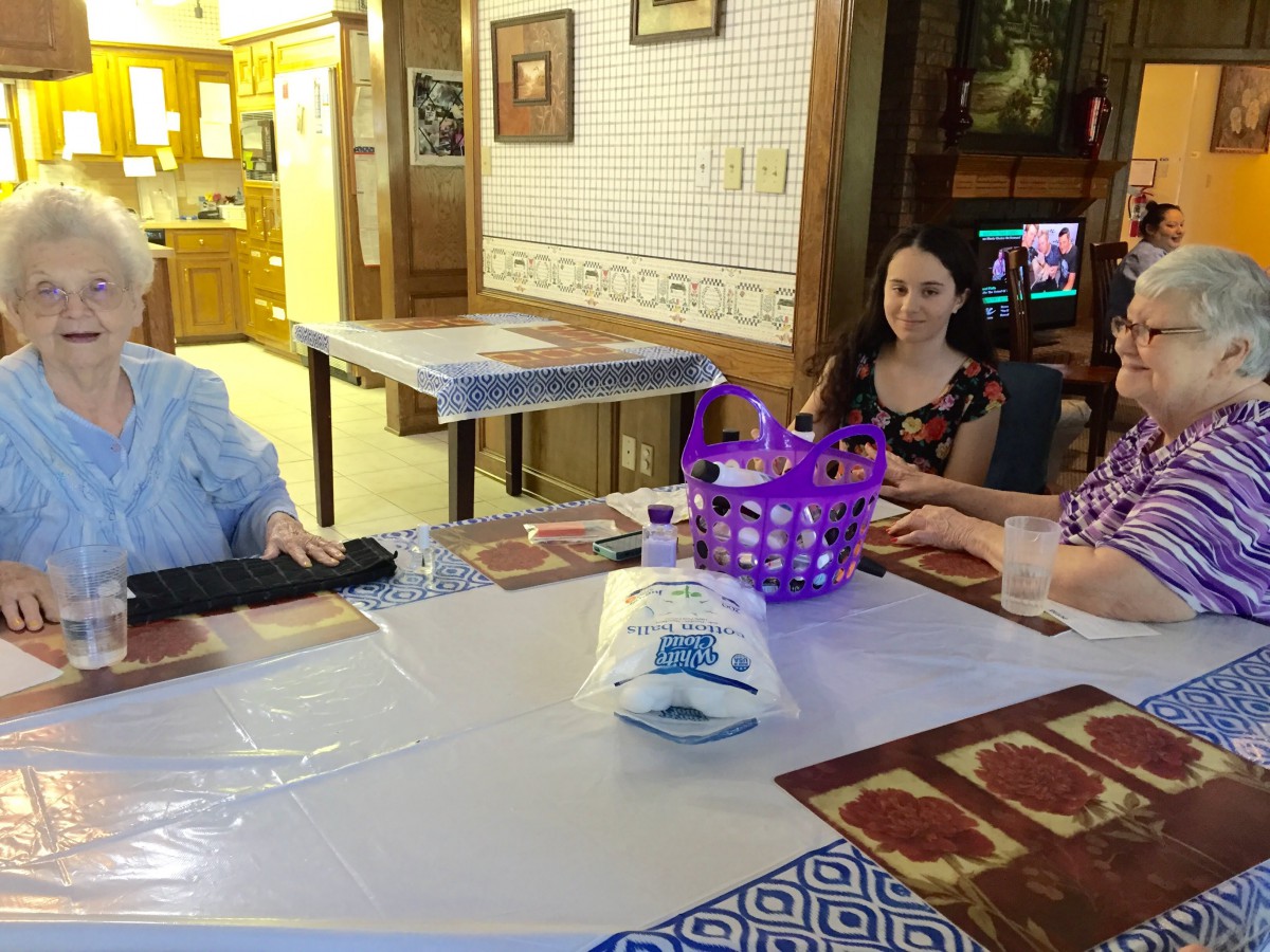 A group of people sitting around a table in a cozy dining area.