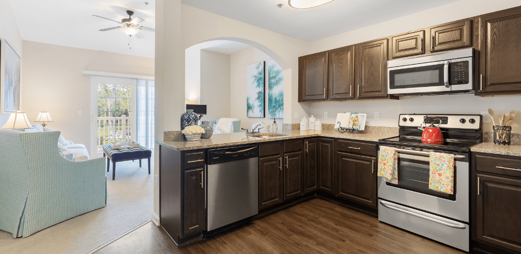 A modern kitchen featuring dark wood cabinets and stainless steel appliances.