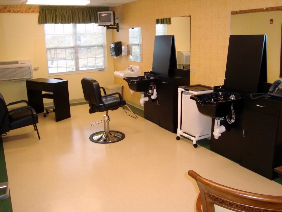 A clean and organized barbershop interior with chairs, mirrors, and sinks.