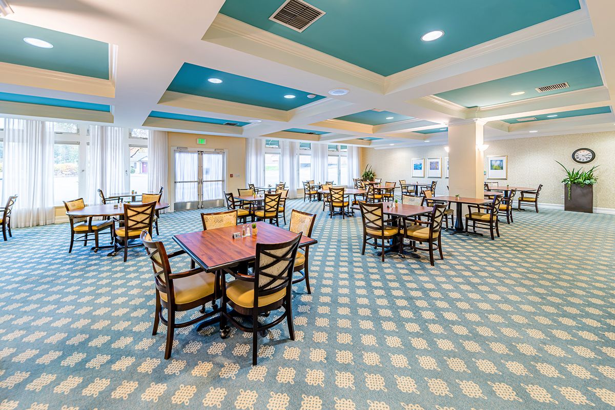 A spacious and neatly arranged dining area with modern decor and ample seating.