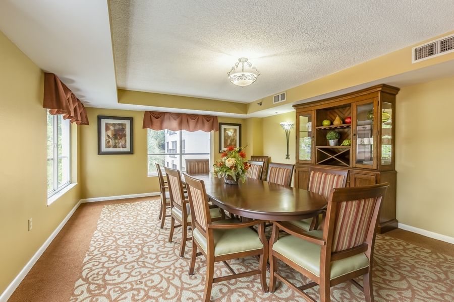 A well-appointed dining room with a large wooden table, matching chairs, and elegant decor.