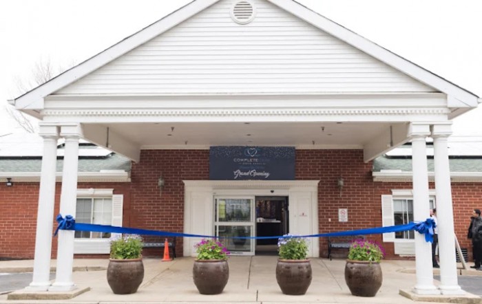 Entrance of a building prepared for a ribbon-cutting event.