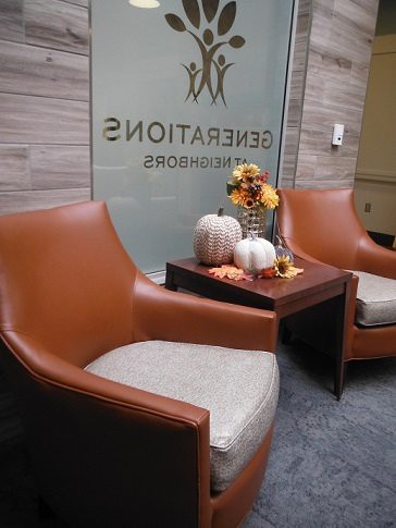 A cozy waiting area decorated with autumn-themed elements including pumpkins and flowers.