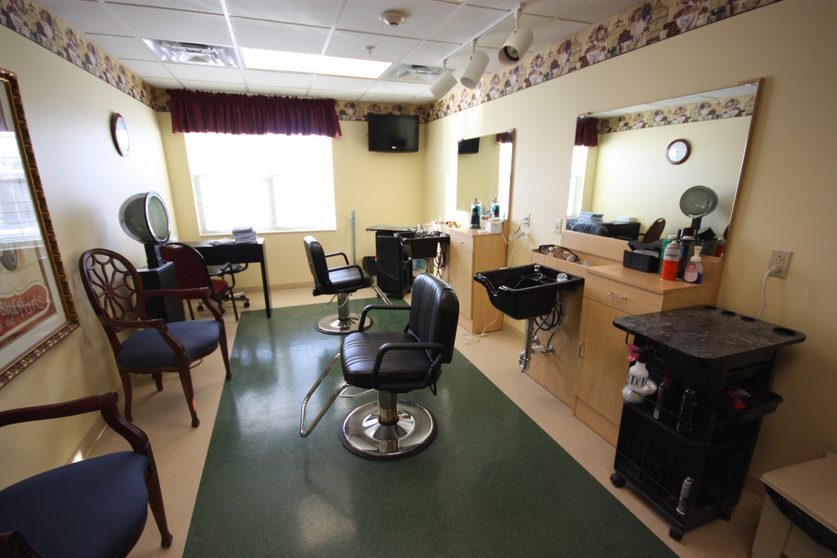 A well-lit hair salon interior with chairs, mirrors, and styling stations.