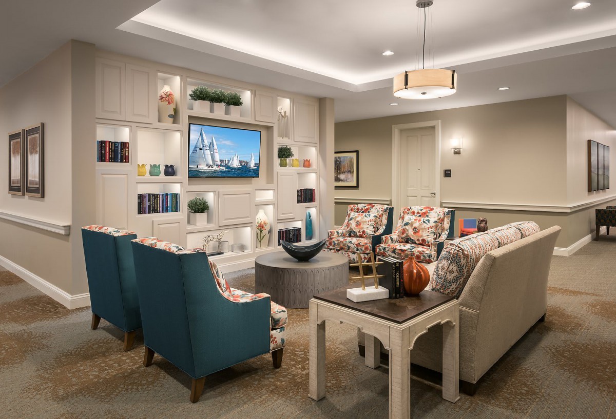 A cozy and well-furnished living room featuring a seating area with sofas and chairs, a television, and modern home decor.