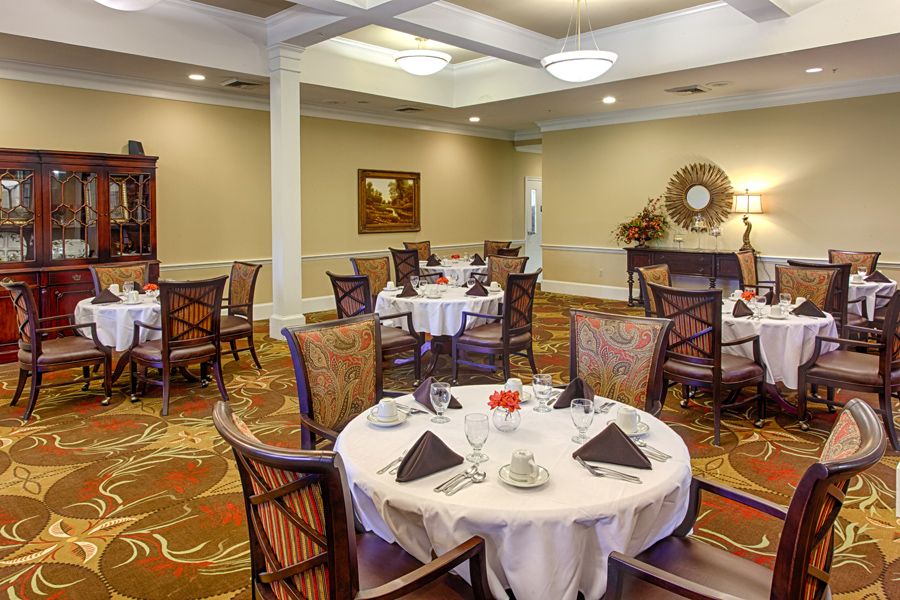 An elegantly decorated dining room with set tables and comfortable seating.