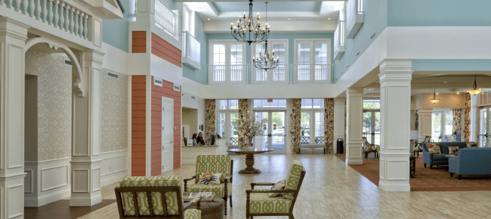 A spacious and elegant lobby area with seating and chandeliers.