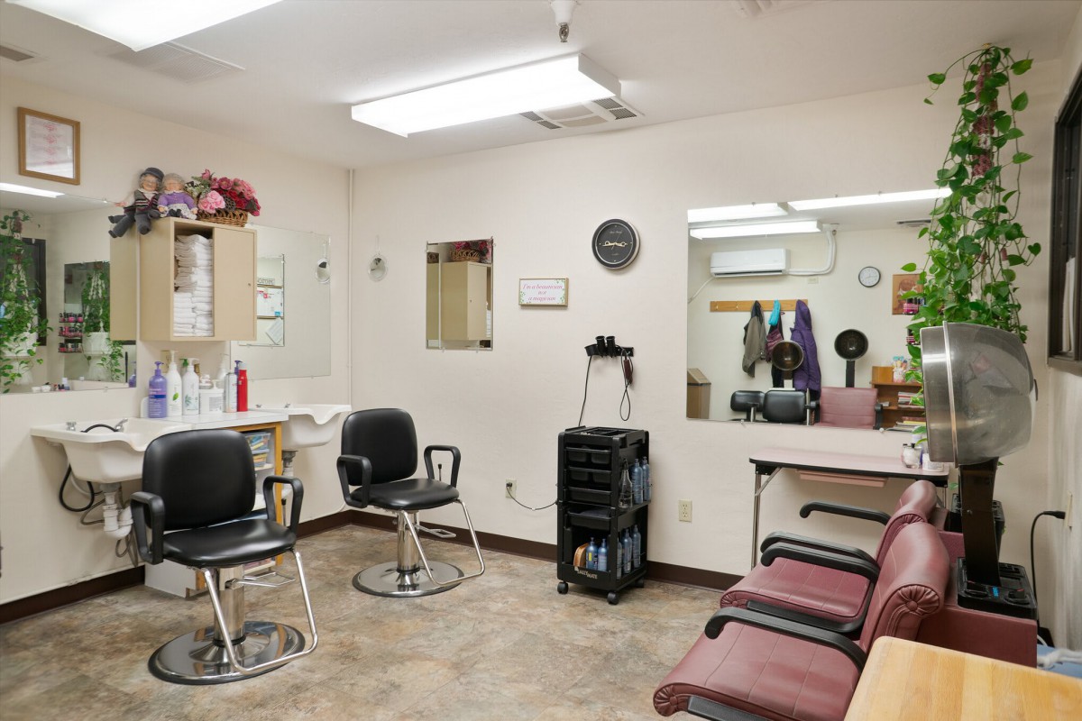 A hair salon with chairs, mirrors, and styling stations.