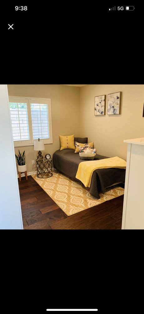A cozy, modern bedroom with warm decor and stylish furnishings.