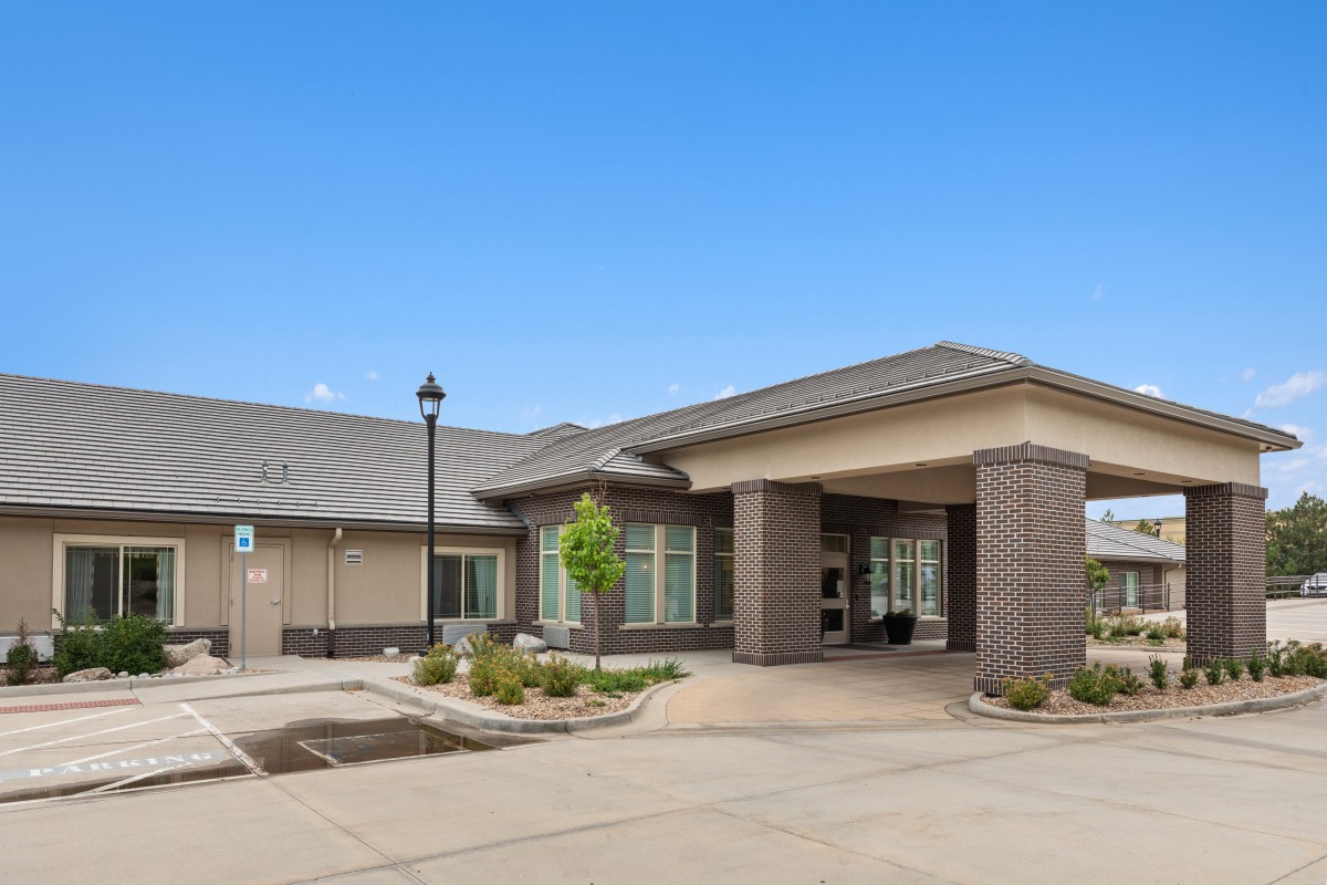 A modern facility with a welcoming entrance and landscaped surroundings.