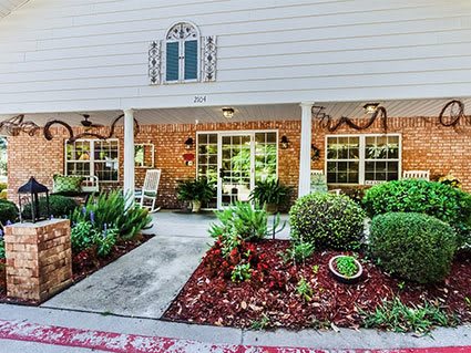 A welcoming front entrance with a landscaped garden and covered porch.