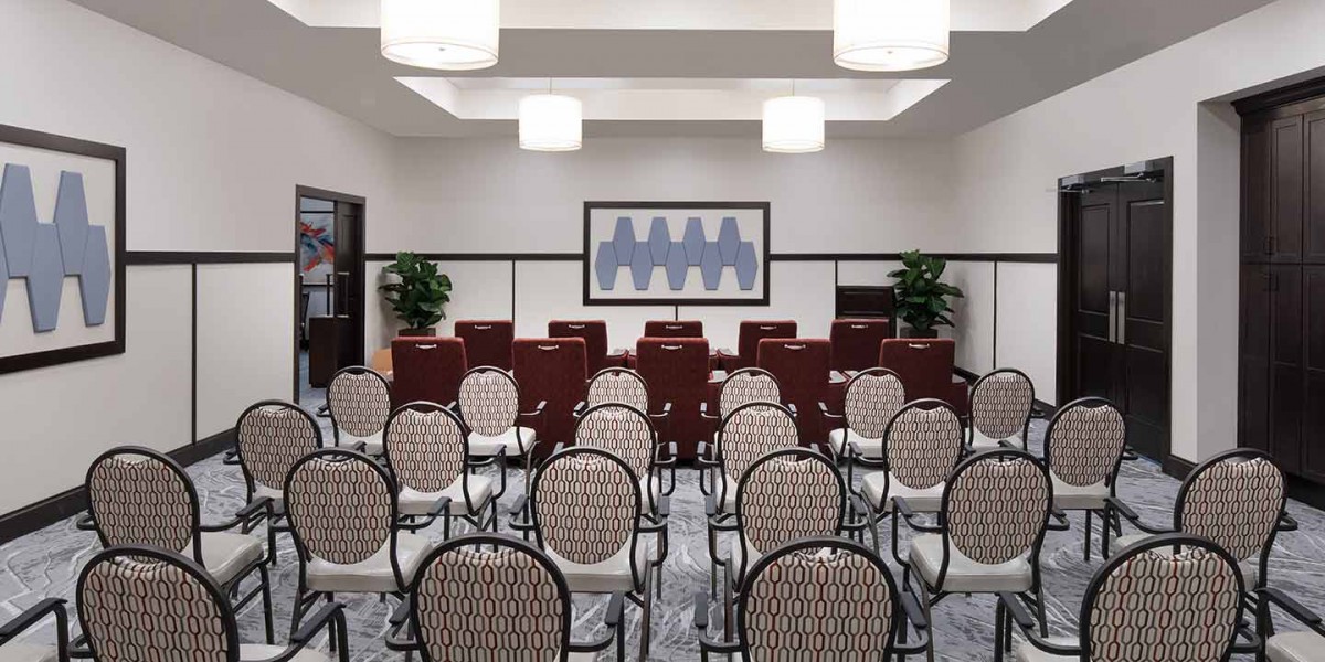 A well-organized conference room with rows of chairs arranged for a meeting or presentation.