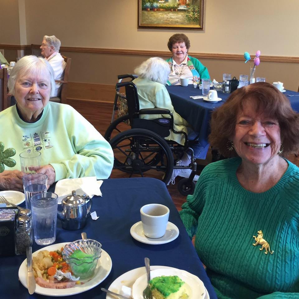Two women enjoying a meal together at a dining table.