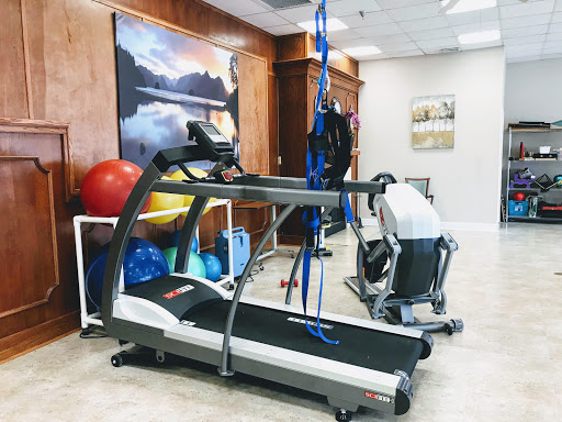 A well-equipped fitness space featuring a treadmill and various training tools.