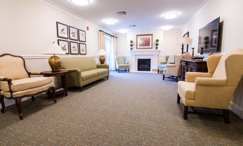 A cozy living room with sofas, chairs, and a fireplace.