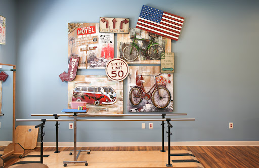 A vibrant display of vintage wall art featuring bicycles, retro signs, and the American flag, enhancing the character of the room.