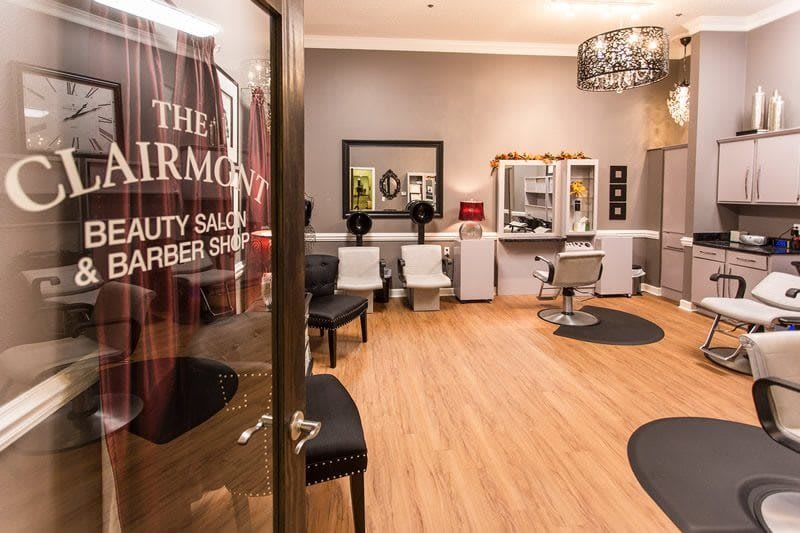 A modern beauty salon and barber shop interior with stylish decor and comfortable seating.