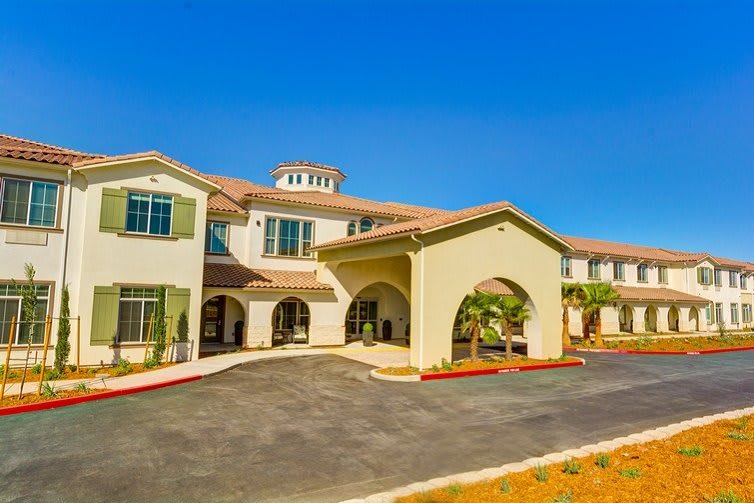 A sunny view of a residential building with a welcoming entrance.