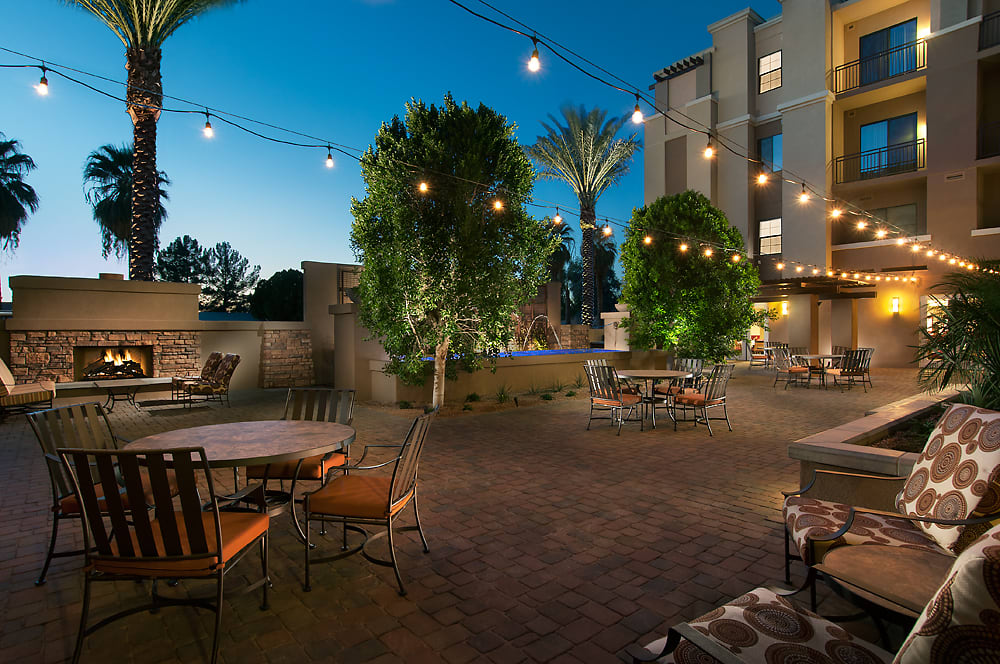 Cozy outdoor patio area with string lights and seating at dusk.