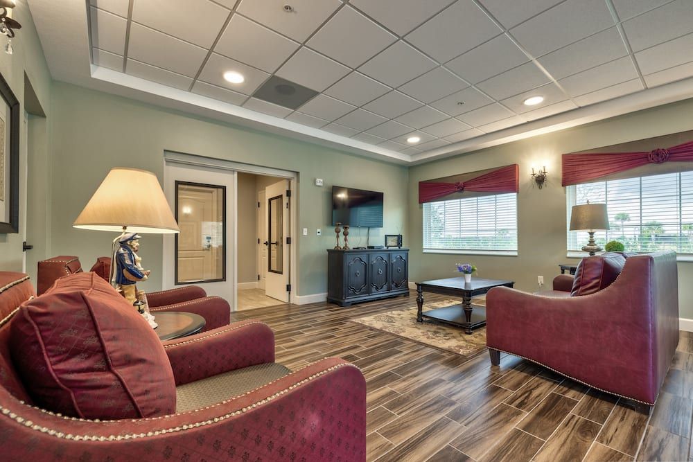 A cozy living room with comfortable seating, a TV, and warm lighting.