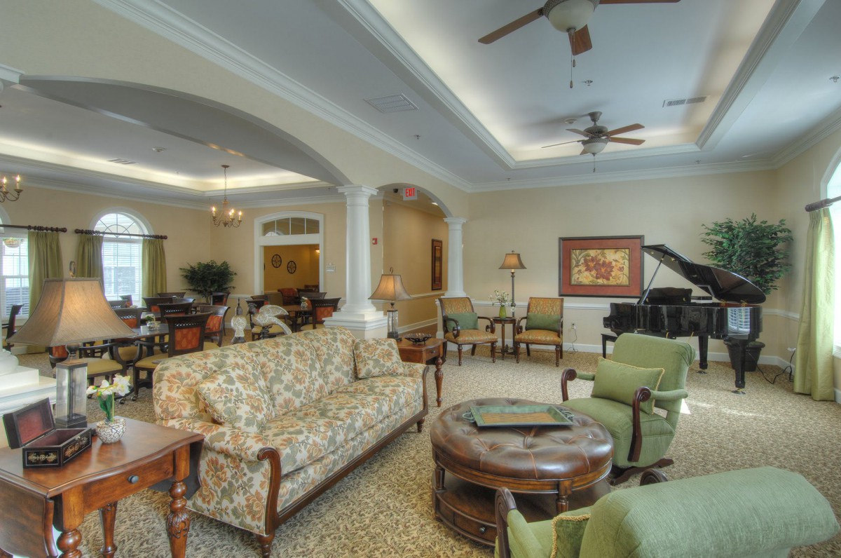 Spacious living room with elegant furniture and a grand piano.