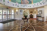 A beautifully decorated lobby entrance with a central table and floral arrangement.