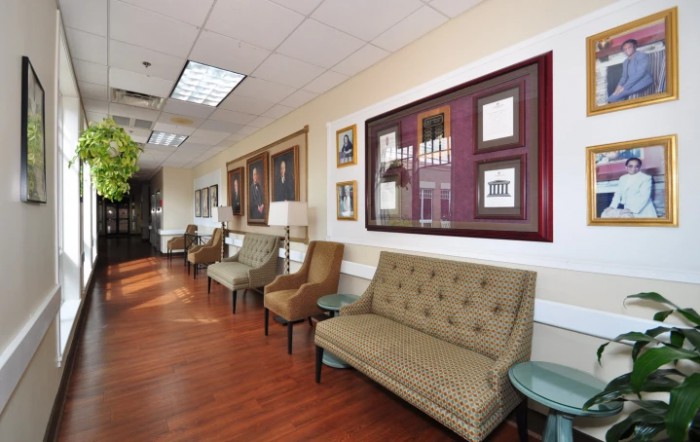 A well-decorated waiting room featuring comfortable seating and framed art on the walls.