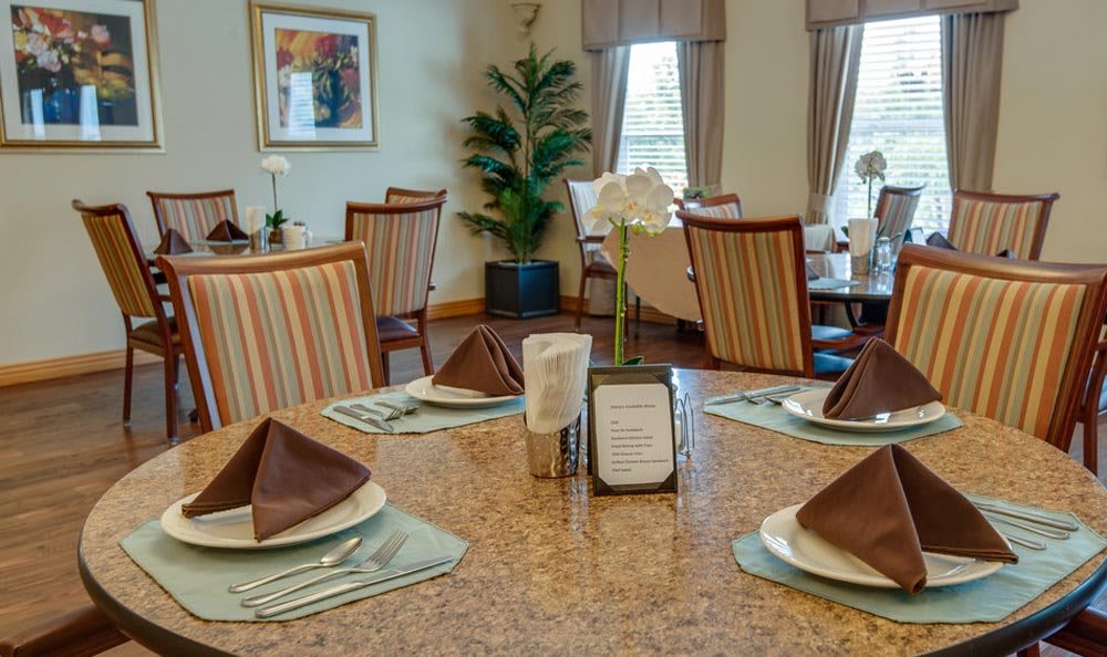 A well-arranged dining area with neatly set tables and elegant decor.