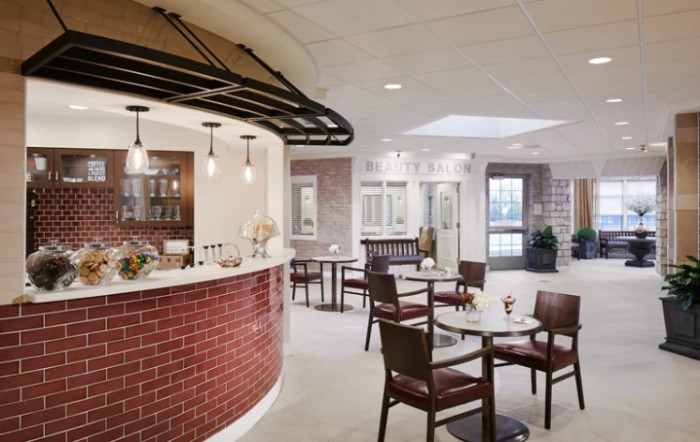 A modern cafe interior with a cozy seating area and bar.