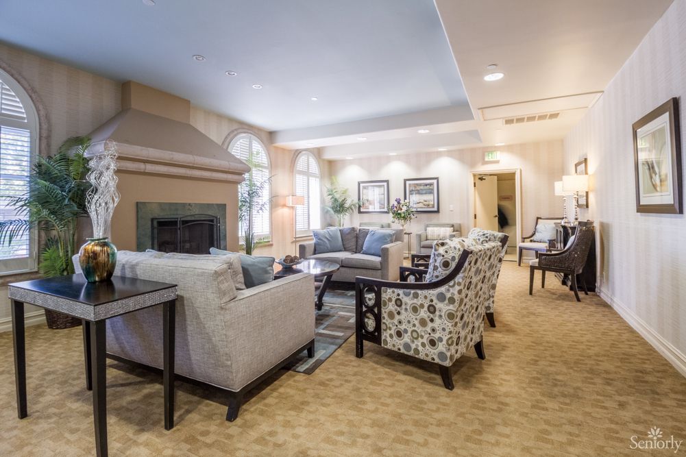 A cozy and elegantly designed living room with comfortable seating and a fireplace.