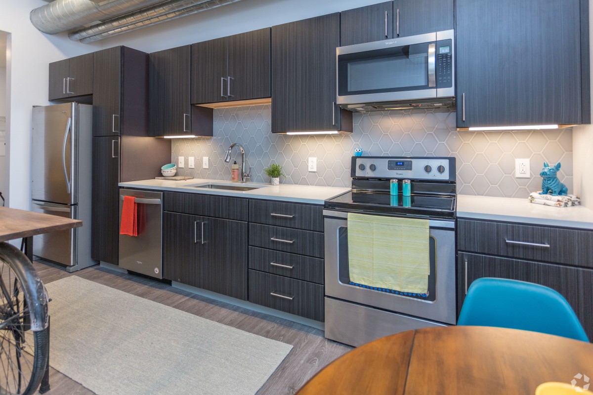 A modern kitchen with sleek cabinetry and stainless steel appliances.