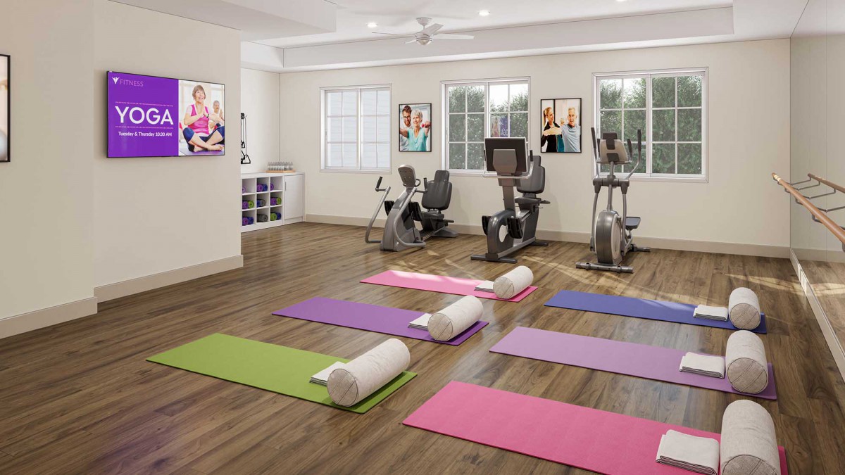 A well-lit gym with yoga mats and exercise bikes, ready for workout sessions.