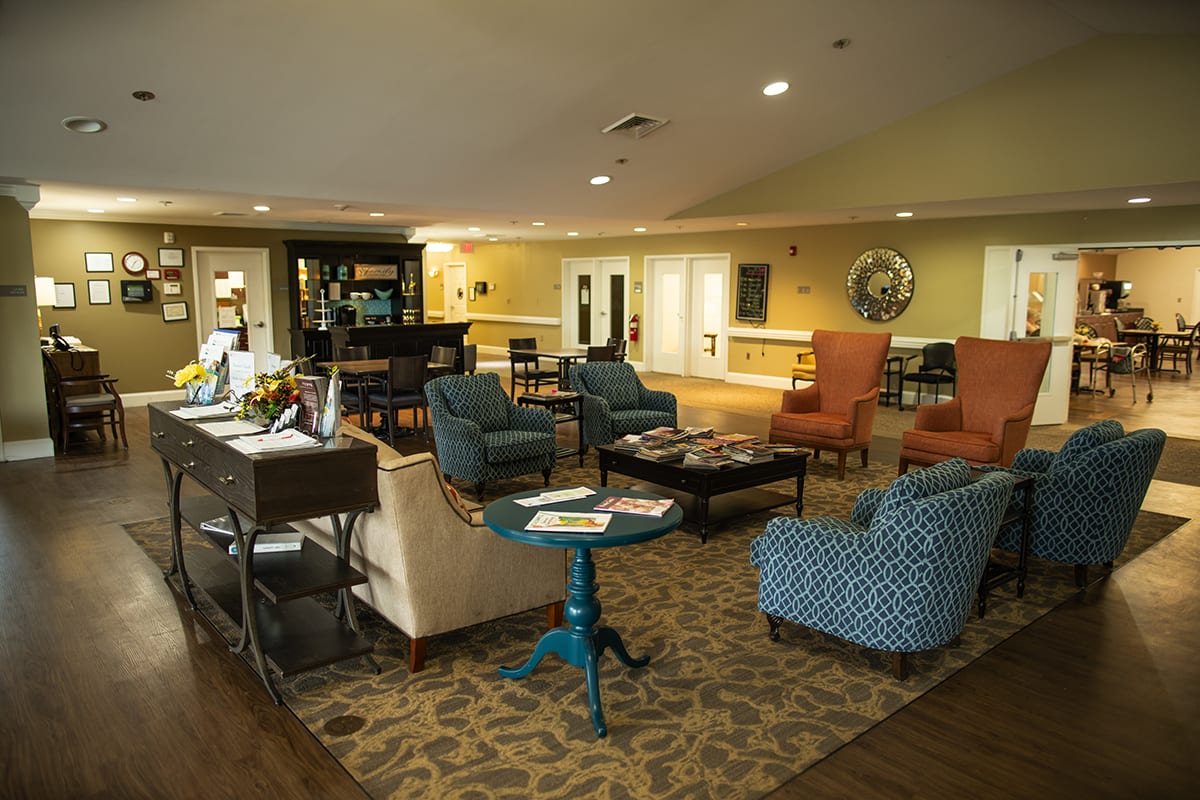 A cozy hotel lobby with various seating options and warm lighting.