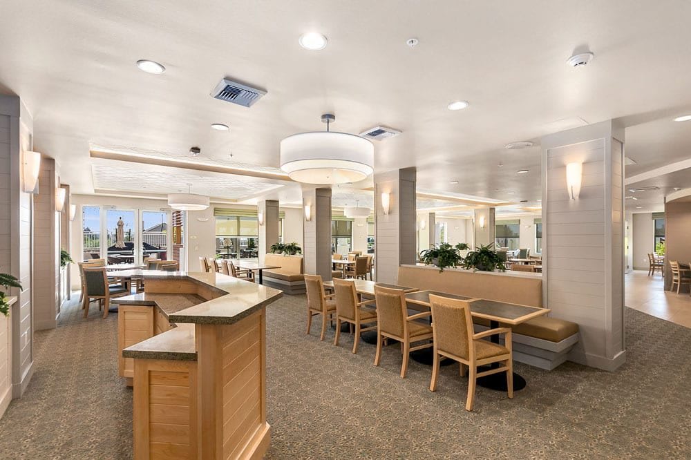 A modern dining area with wooden furniture and bright lighting.