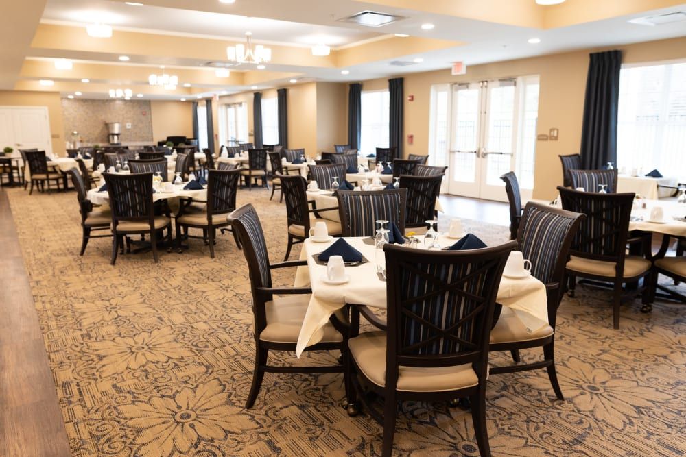 A spacious and elegantly decorated dining room with neatly arranged tables and chairs.