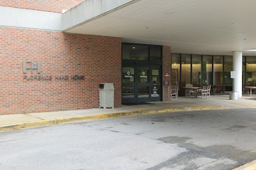 Entrance of a modern brick building featuring large glass windows.
