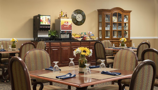A cozy dining area with neatly arranged tables and a buffet station, perfect for casual meals.
