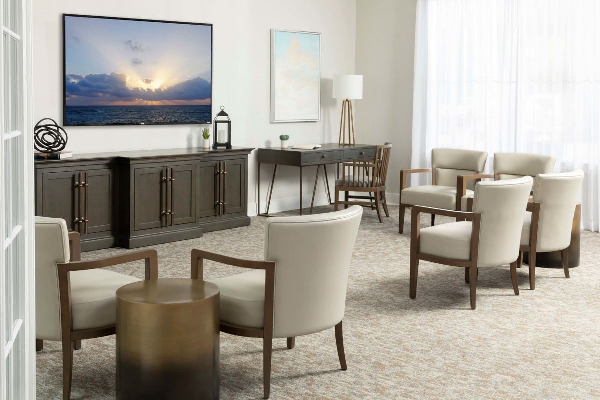 A modern living room with contemporary furniture and a large television.