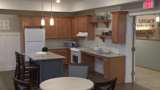 A modern kitchen showcasing wooden cabinetry, white appliances, and a cozy dining space.