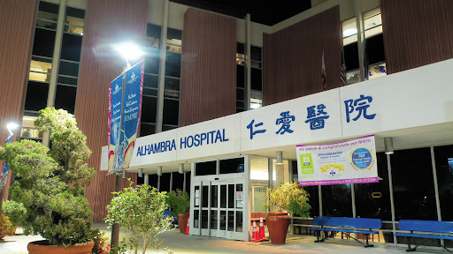 Alhambra Hospital illuminated at night.