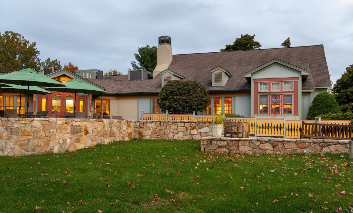 A charming house with stone walls and a well-maintained garden.