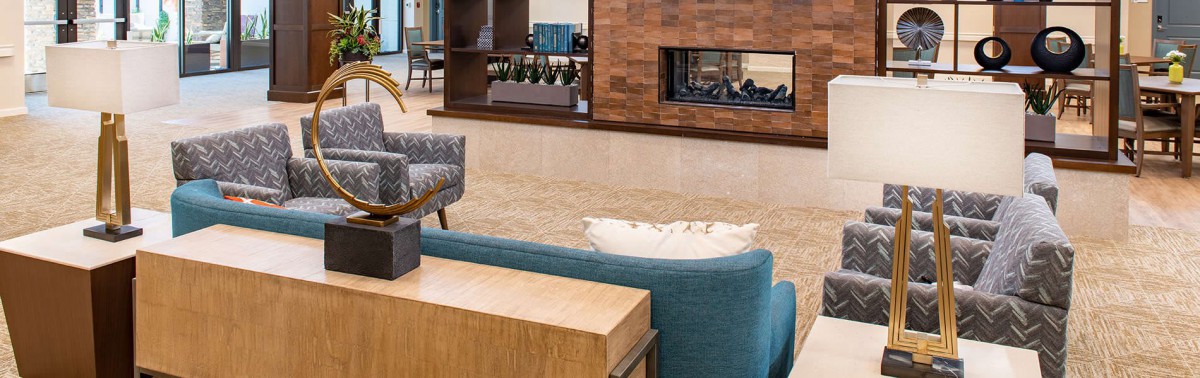 A modern living room featuring a cozy sofa and a stylish fireplace.