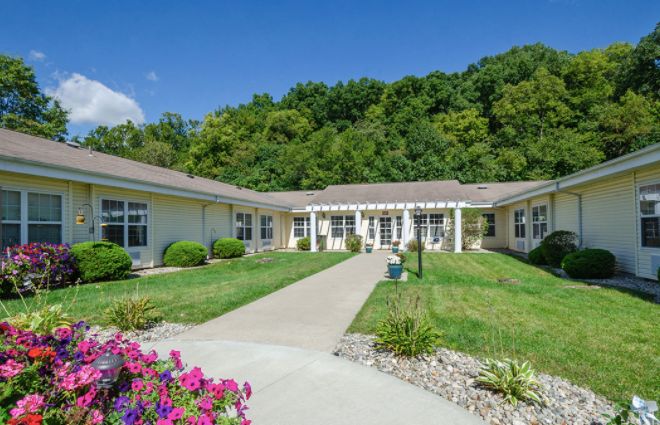 A peaceful building surrounded by lush greenery and a well-maintained garden.