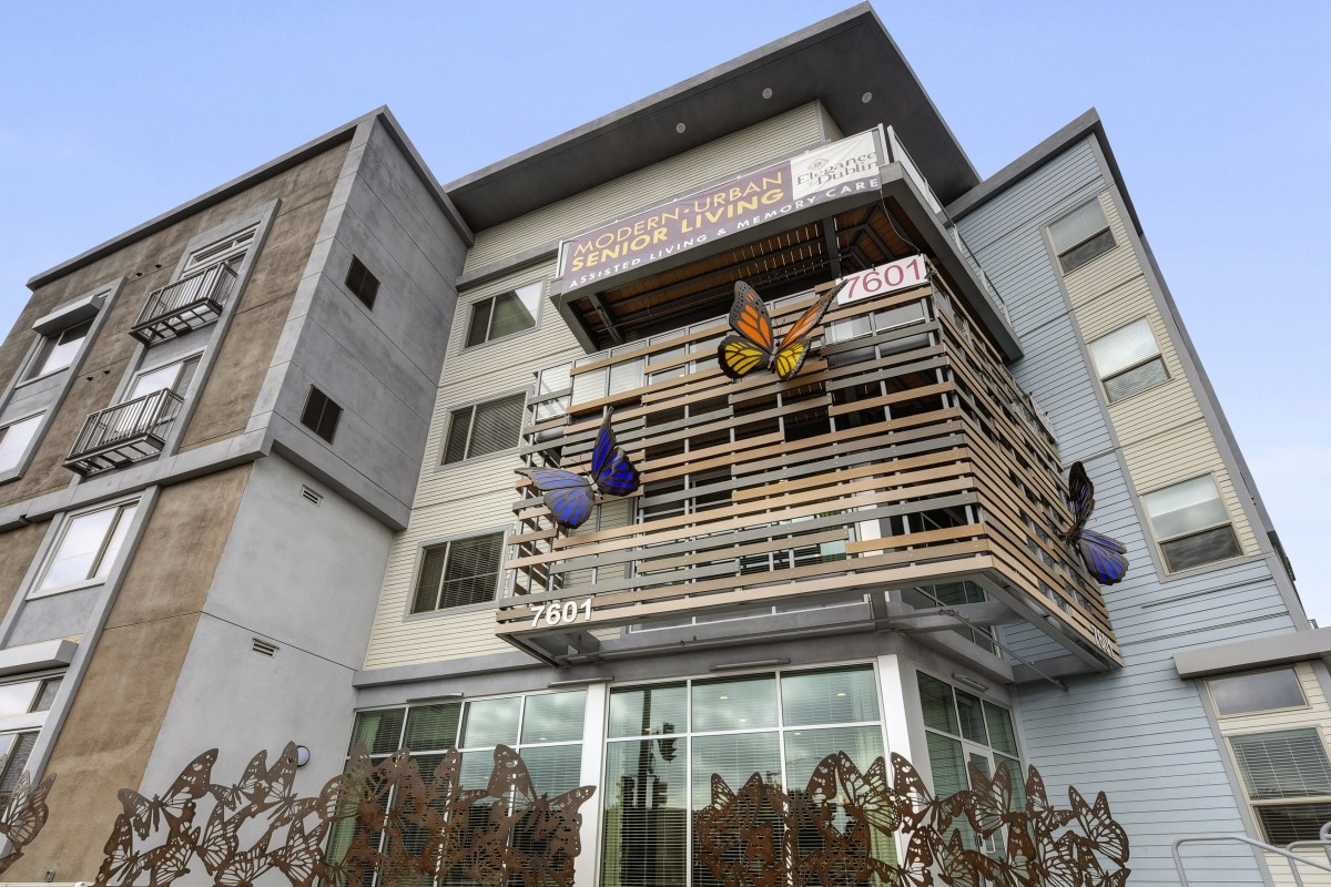 A modern building adorned with large butterfly sculptures on its facade.